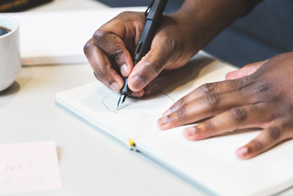 person drawing and writing