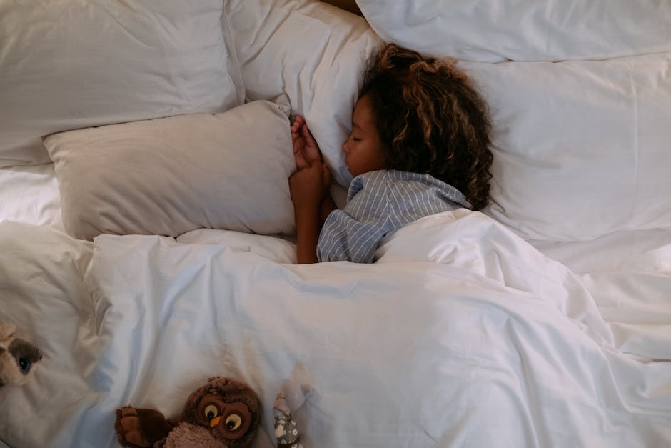 child sleeping in bed