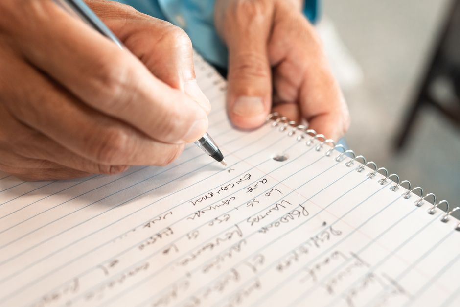 person writing notes about linguistics