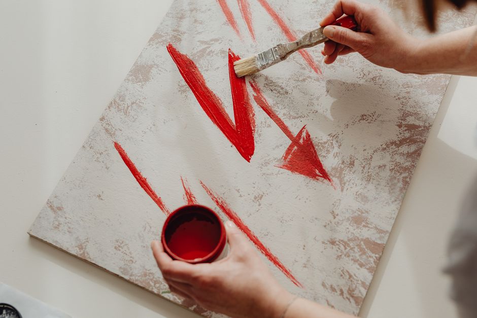 person painting a canvas