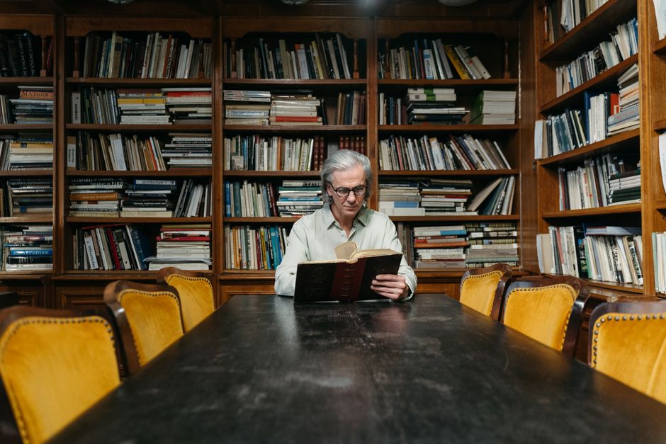 person reading a book in a library