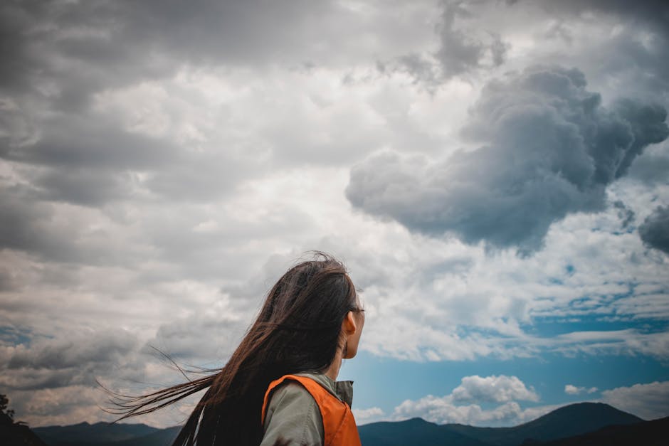 person looking at cloudy sky