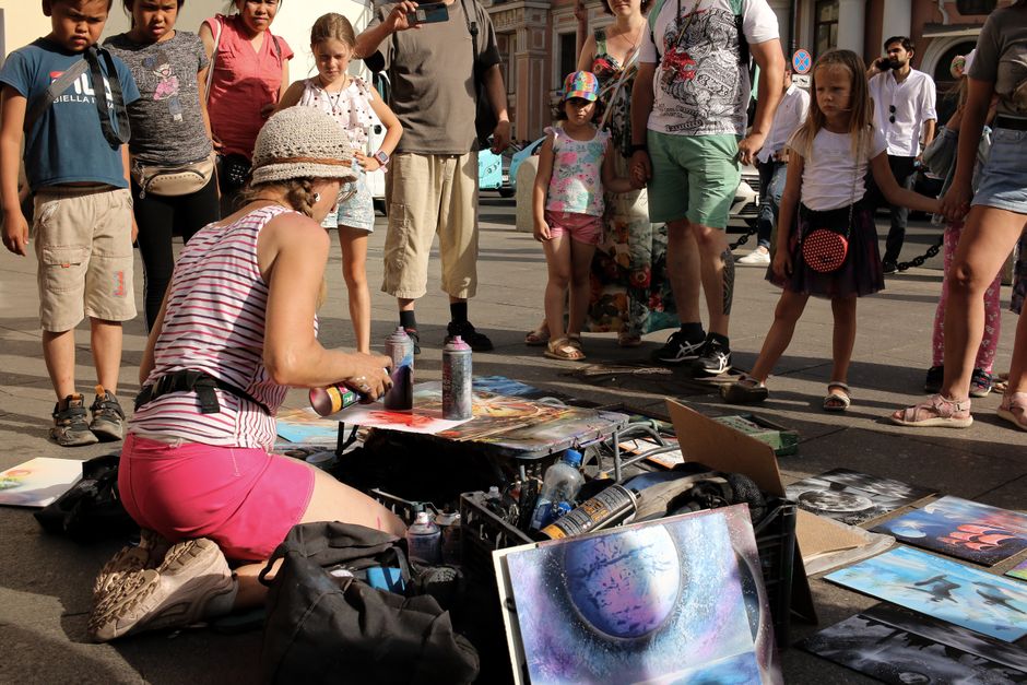 people engaged in street art